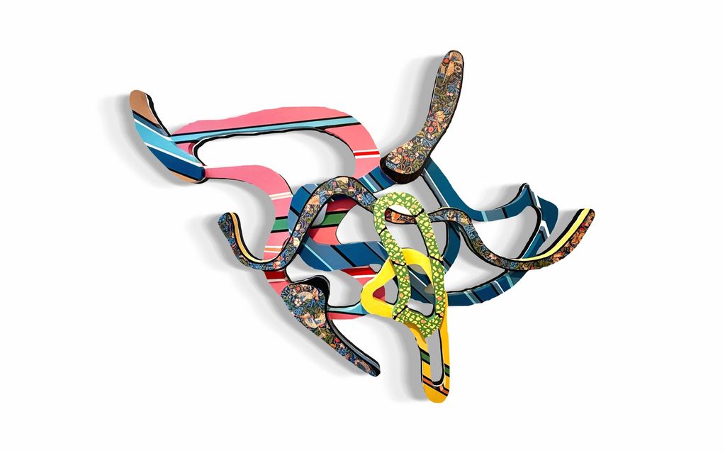 Colorful abstract wall sculpture with curved, intertwined shapes.