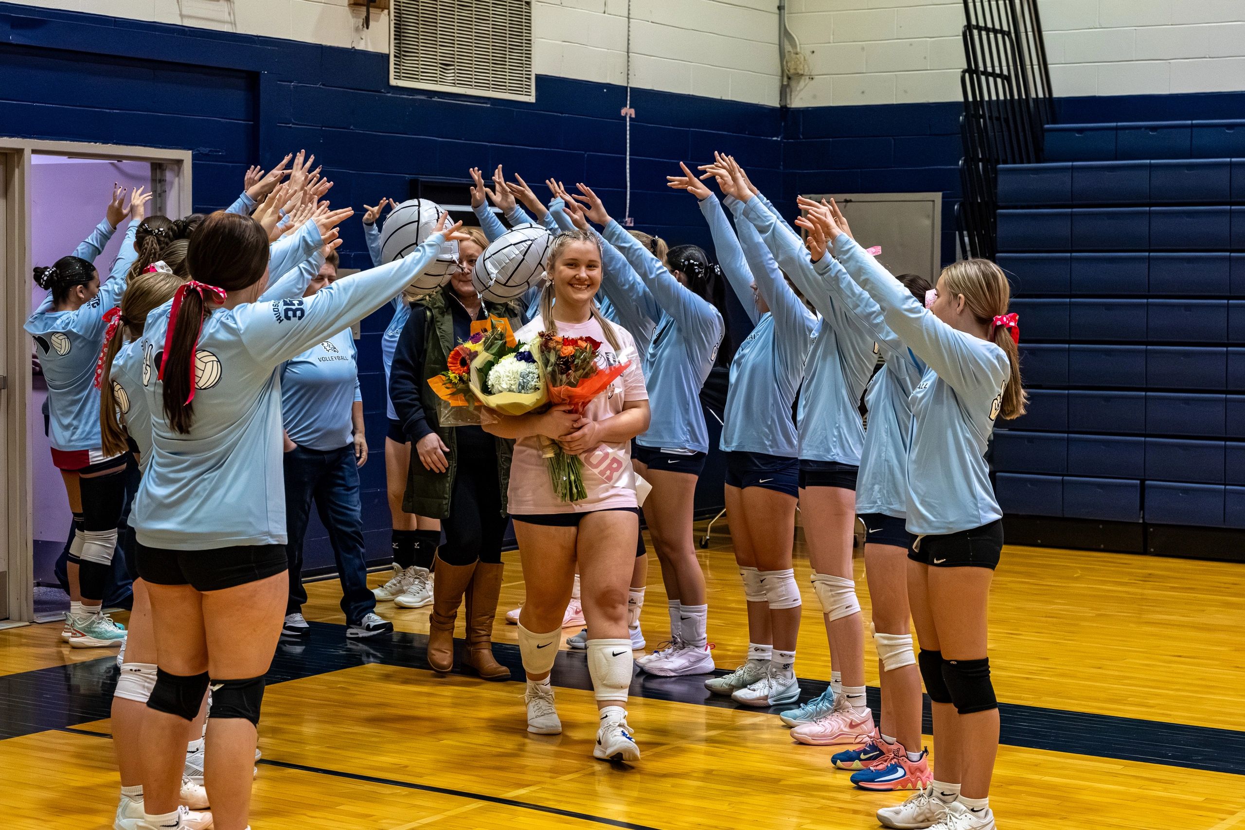volleyball players walking through team tunnel