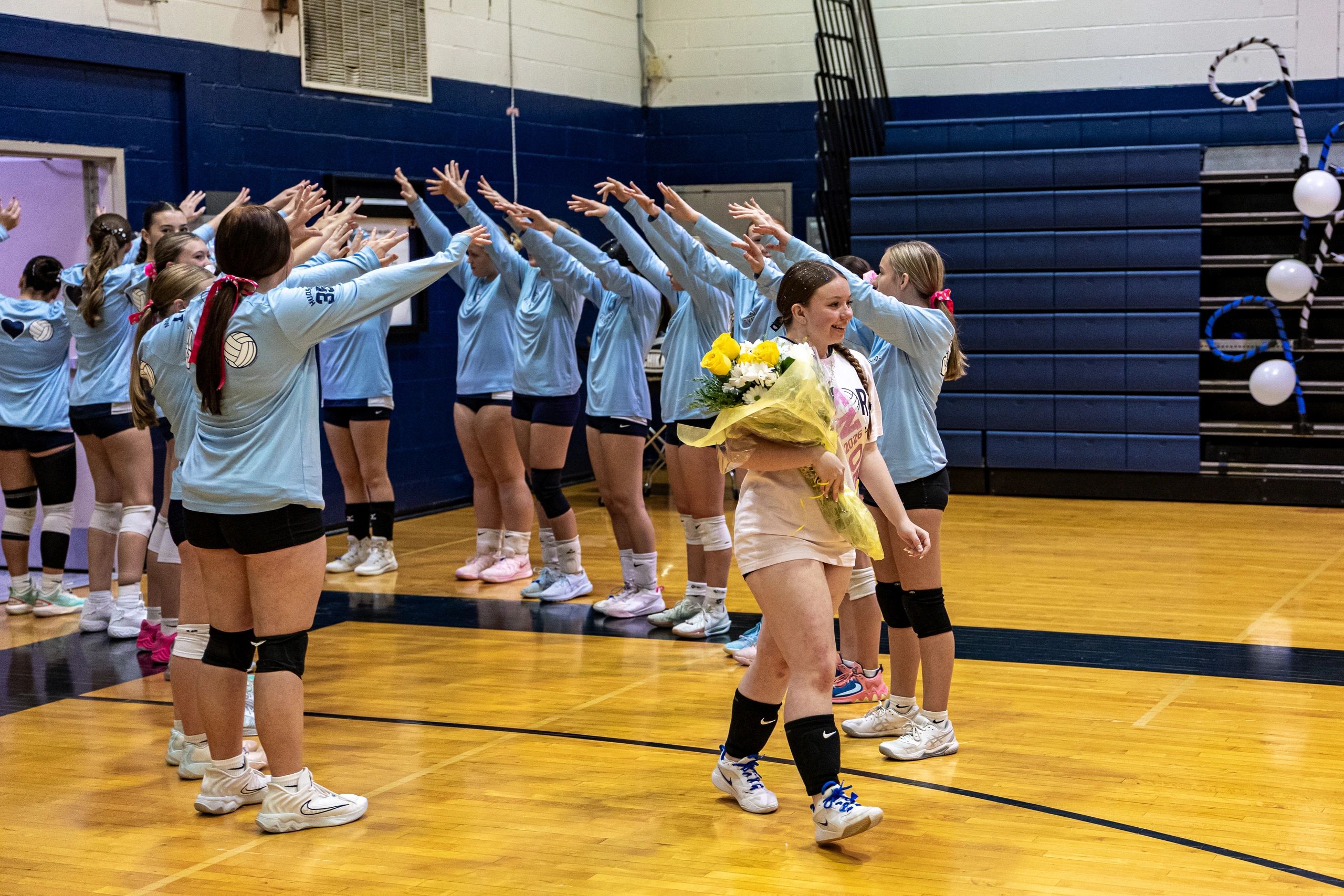 volleyball players walking through team tunnel