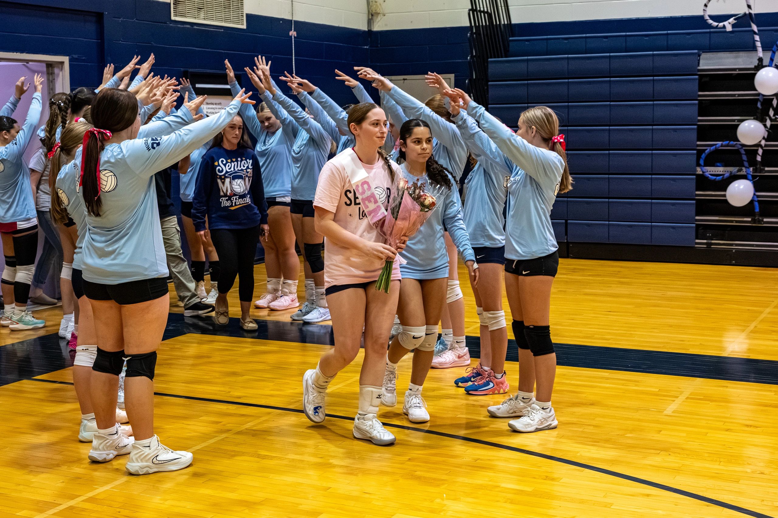 volleyball players walking through team tunnel