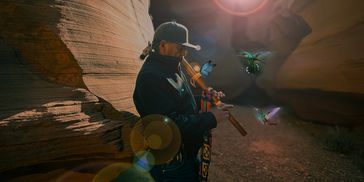 playing the Native American flute in the canyon