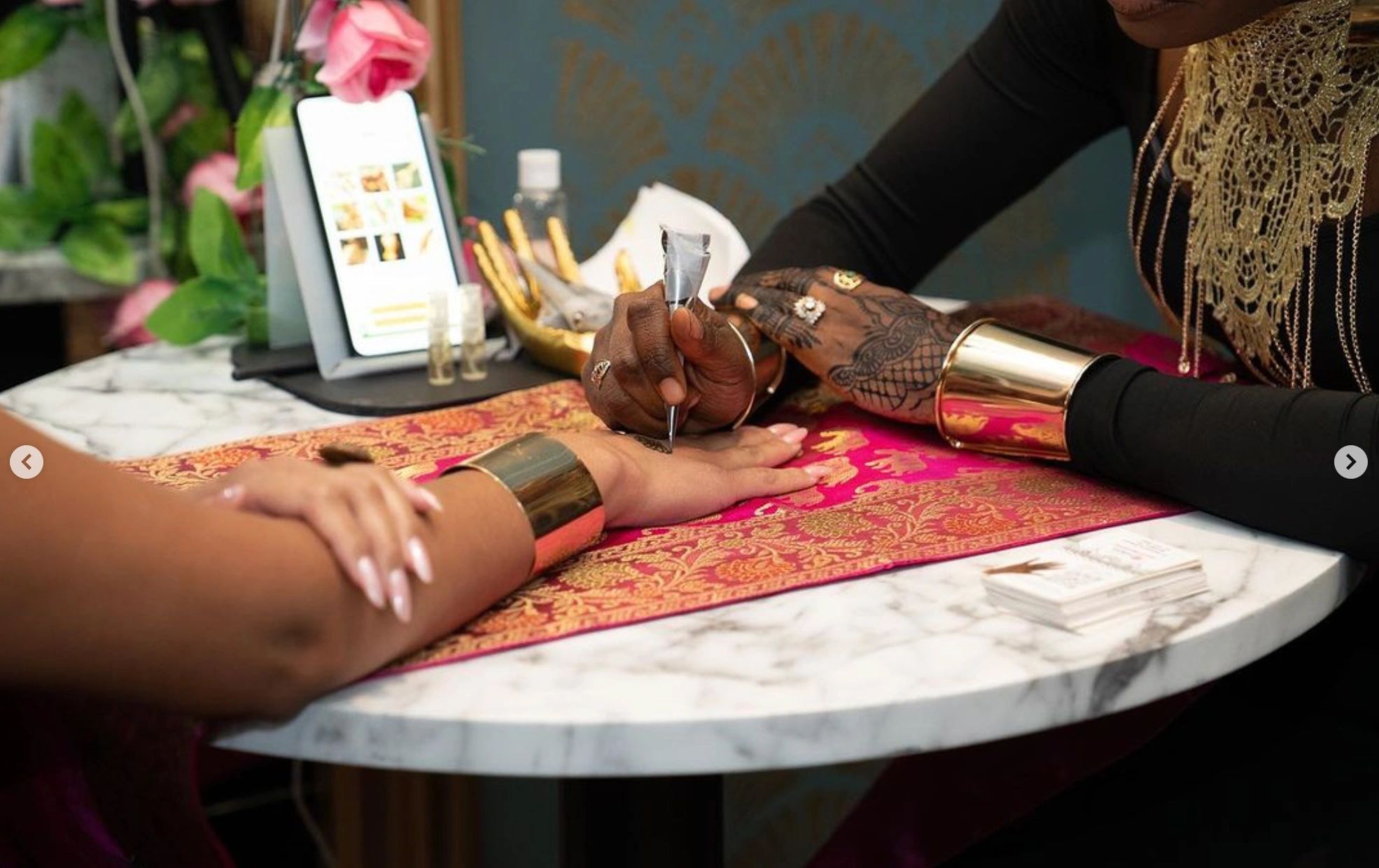 artist applying henna, cone close-up on hand