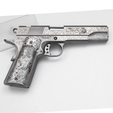 Intricately engraved silver handgun with detailed floral and star patterns.