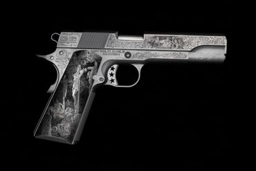 Ornate silver pistol with detailed engravings and intricate artwork on the handle and body.