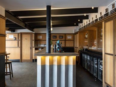 Modern bar interior with wooden accents and sleek design.