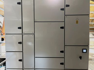 Large industrial electrical control panel with multiple compartments and access doors.
