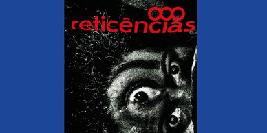 Black and white intense close-up face with red text 'reticências' above.