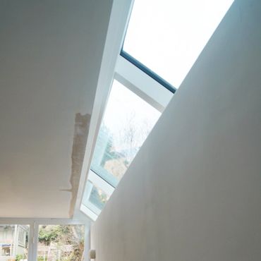Skylight window illuminating a minimalist interior space.
