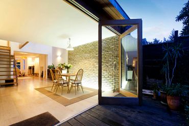 Modern open dining area with glass doors leading outside.