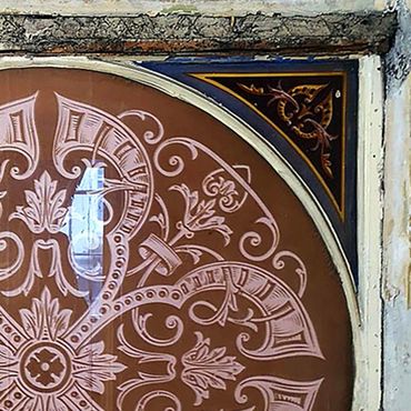 Intricate floral and geometric patterns on a decorative circular panel.