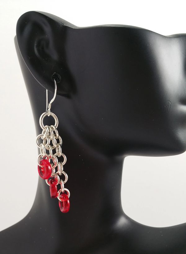 A mannequin wearing red earrings
