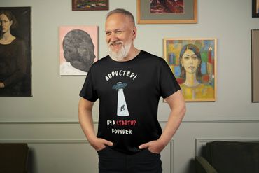 Black T-shirt, paired with the humorous phrase "Abducted by a Startup Founder"