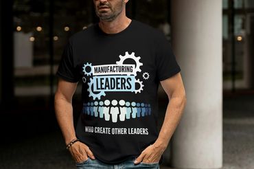 Black T-shirt featuring slogan 'Manufacturing Leaders Who Create Other Leaders'