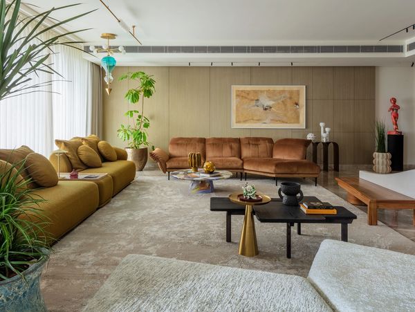Spacious modern living room with earthy tones and stylish decor.