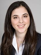 Professional portrait of a smiling woman with long dark hair.