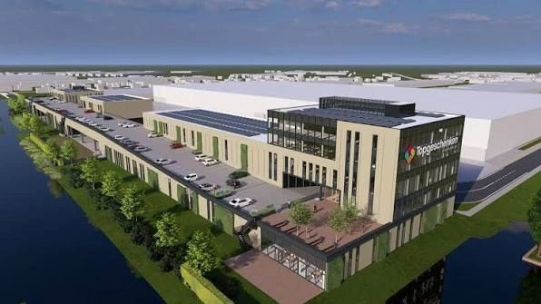 Modern industrial building with parking and water views.