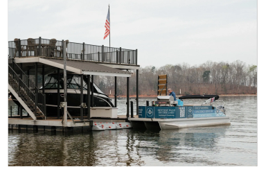 Small boat moored near a dock with an American flag.