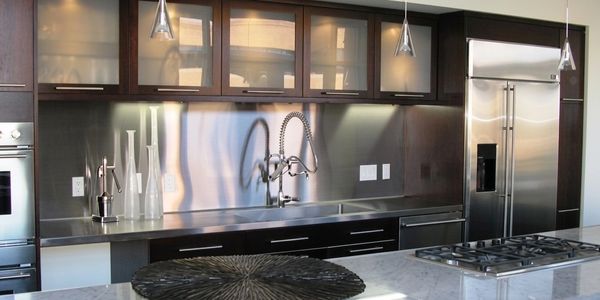 Custom stainless steel kitchen backsplash and wall panels by Tin Works in modern kitchen