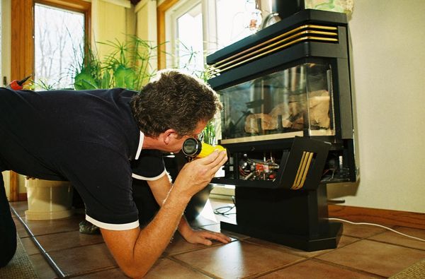 Chimney technician inspecting a fireplace