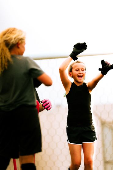 Young soccer players celebrating joyfully on the field.