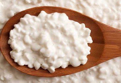 Wooden spoon with cottage cheese