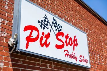 A signage board of the Pit Stop Hobby Shop