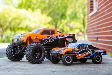 RC car in two sizes in orange color near the shop
