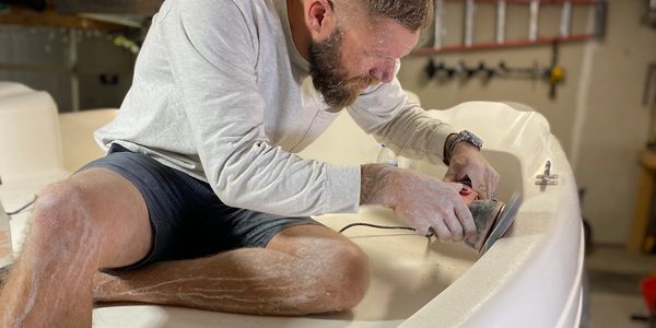 Wet sanding, buffing, compounding and polishing one of our happy customer's boat