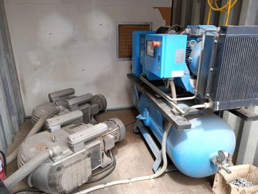 Full feature rotary screw air compressor and vacuum pumps in factory a plant room
