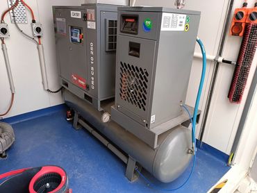 Industrial air compressor unit in a workshop.