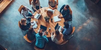 Team gathered around table for a meeting.