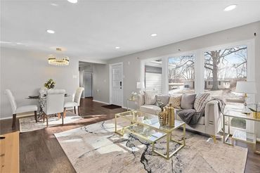 Bright living and dining area with modern decor and large windows.