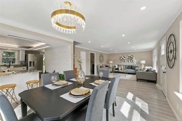 Modern open-plan dining and living area with elegant decor and natural light.