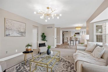 Bright living room with modern furniture and neutral tones.