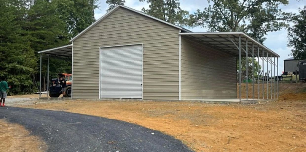 A garage with two people standing on the side of it.