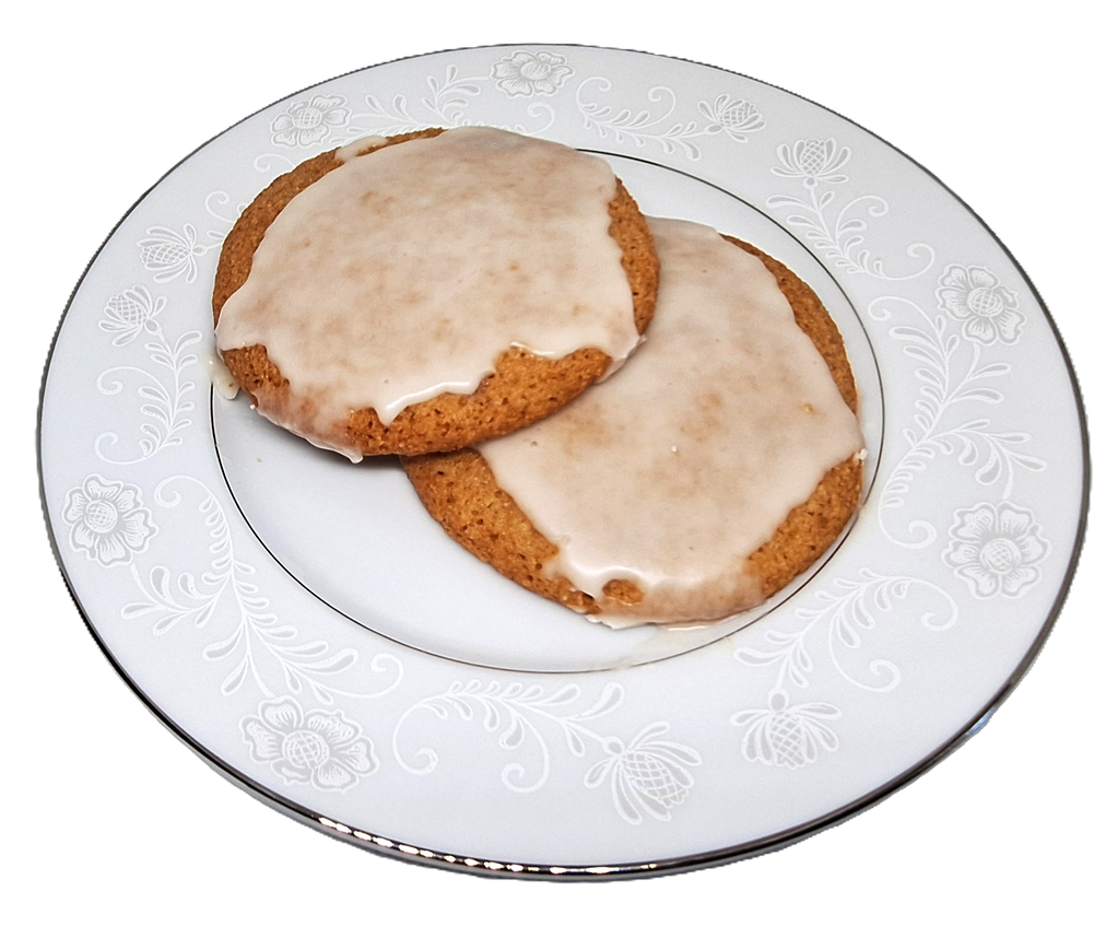 Two lemon iced cookies on a plate