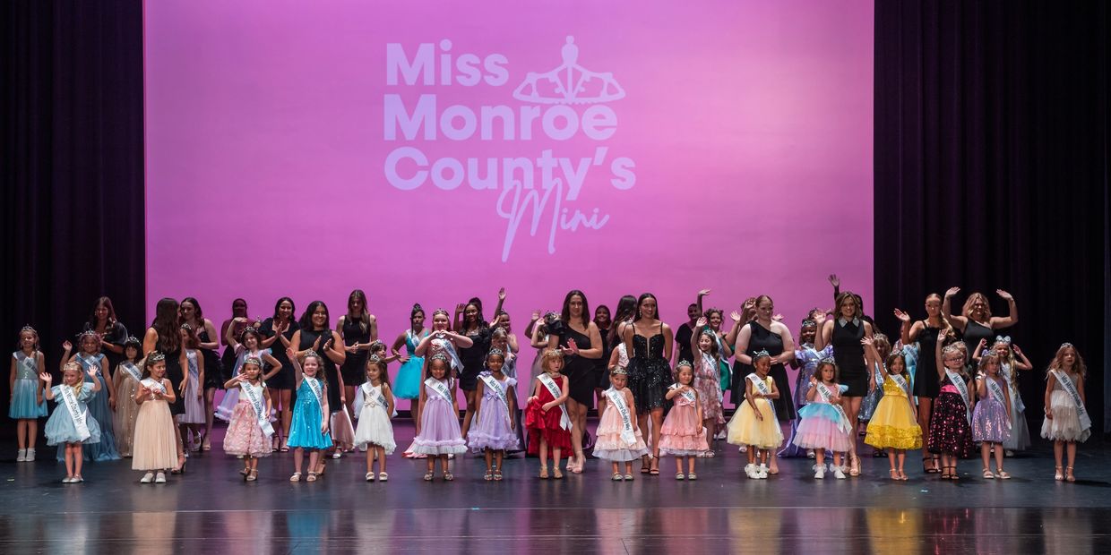 Young contestants and adults on stage at Miss Monroe County's Mini pageant.