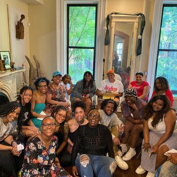 Group of People Sitting in a Living Room Together