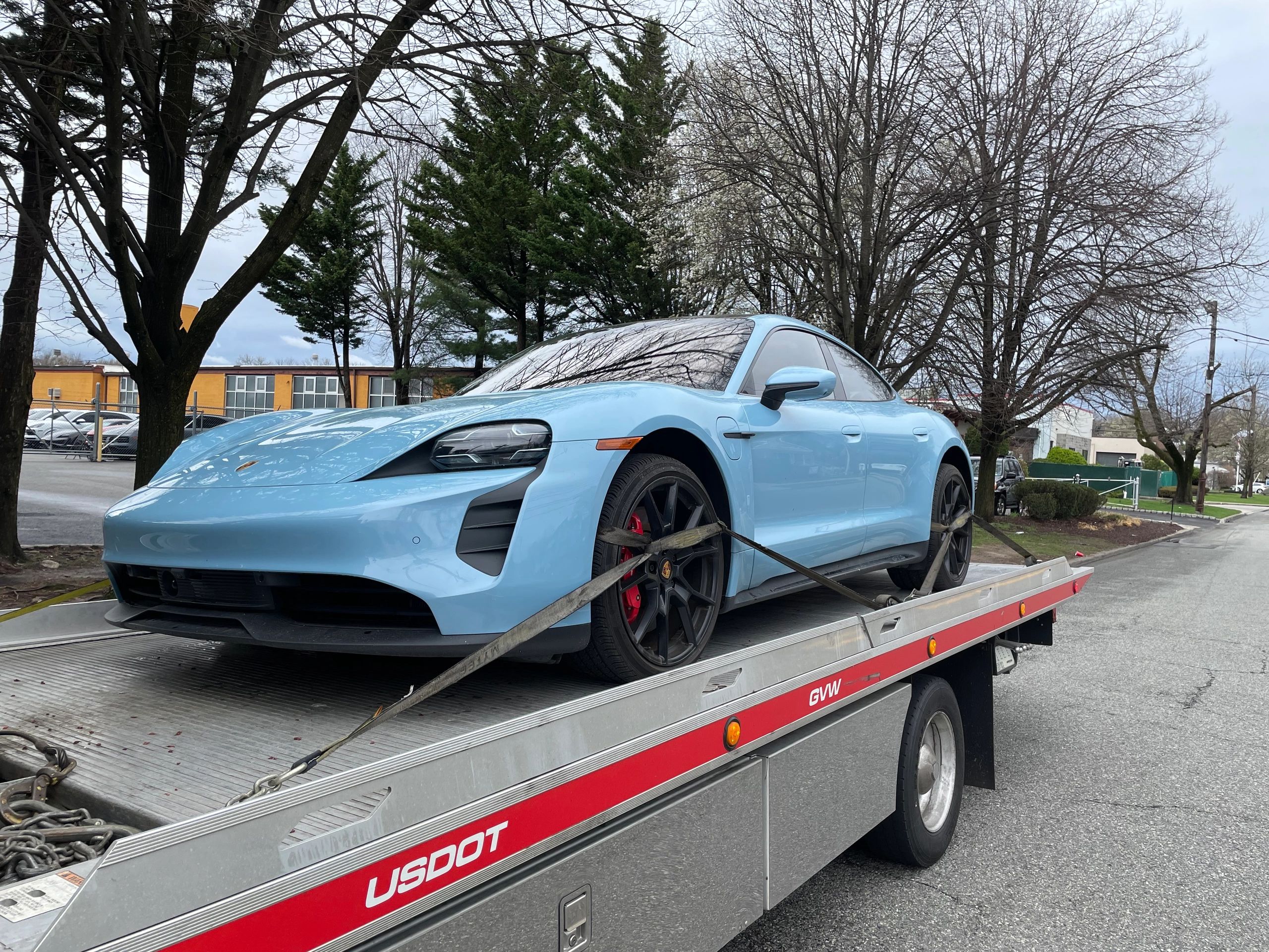 Baby blue Porsche Panamera safely being transported 