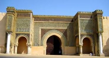 Ornate Islamic architectural gate with arches and intricate tile work.
