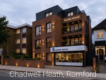 Modern brick office building with Bajwa Group signage during dusk.