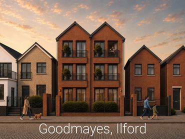 Modern brick townhouses with people walking dogs at sunset.