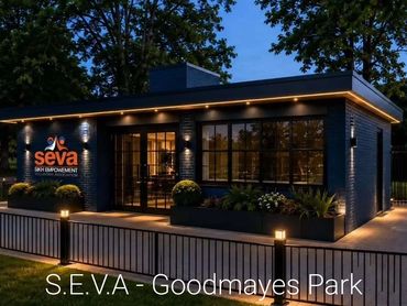 Modern building of Seva Skin Empowerment lit up at night.