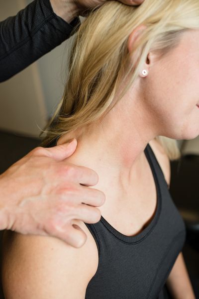 Chiropractor stretching a patient's neck.