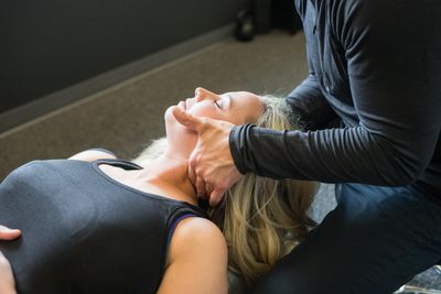 Patient getting neck adjusted at chiropractic office in Lincoln, NE