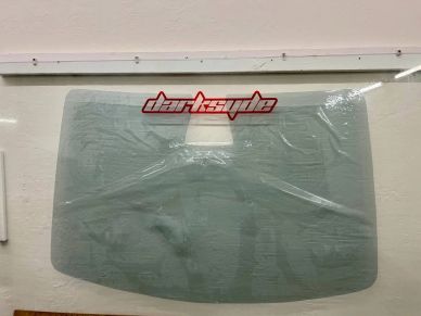 Clear car windshield with a darksyde logo.