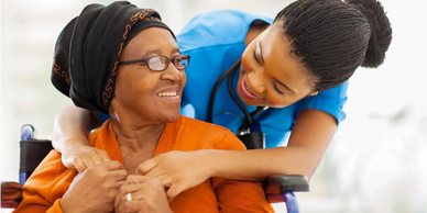 Caregiver assisting an elderly woman with daily care at home