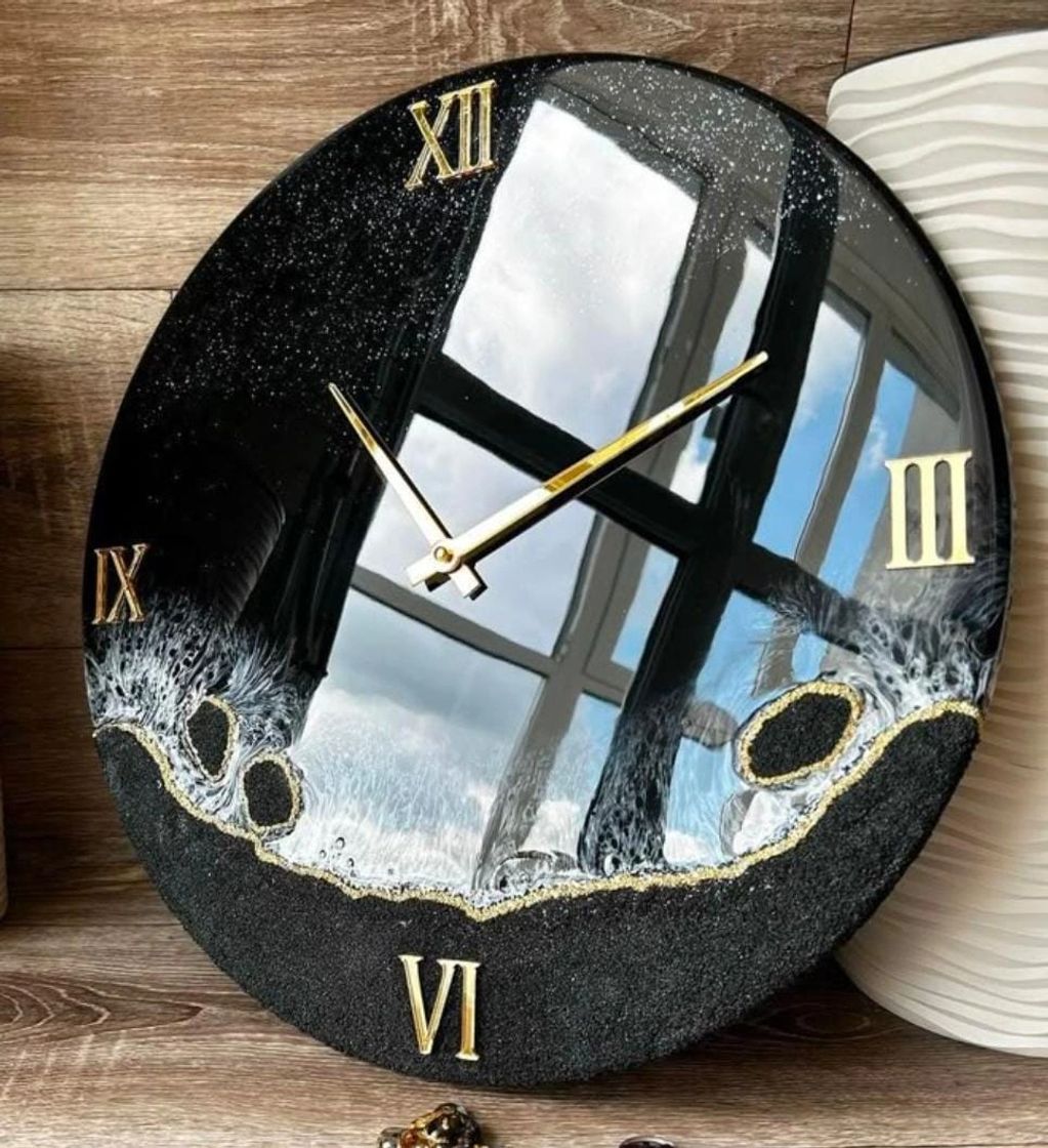 handcrafted resin wall clock, designed with a bold black base, shimmering ocean-inspired waves.
