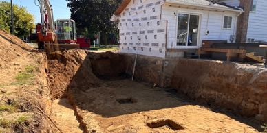 Basement excavation for home addition in Plymouth Michigan. site water management installed