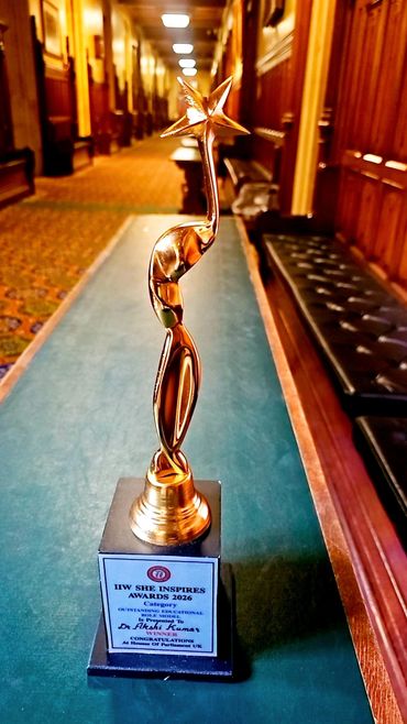 Golden award trophy with a star on top, placed on a table in a wood-paneled hallway.